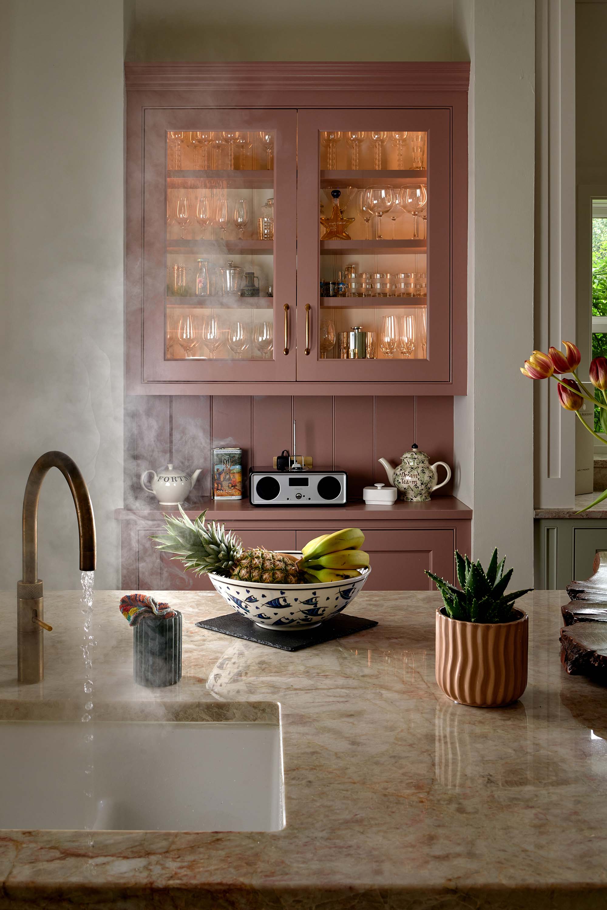 Quooker boiling tap and glazed display cupboard in a traditional shaker kitchen